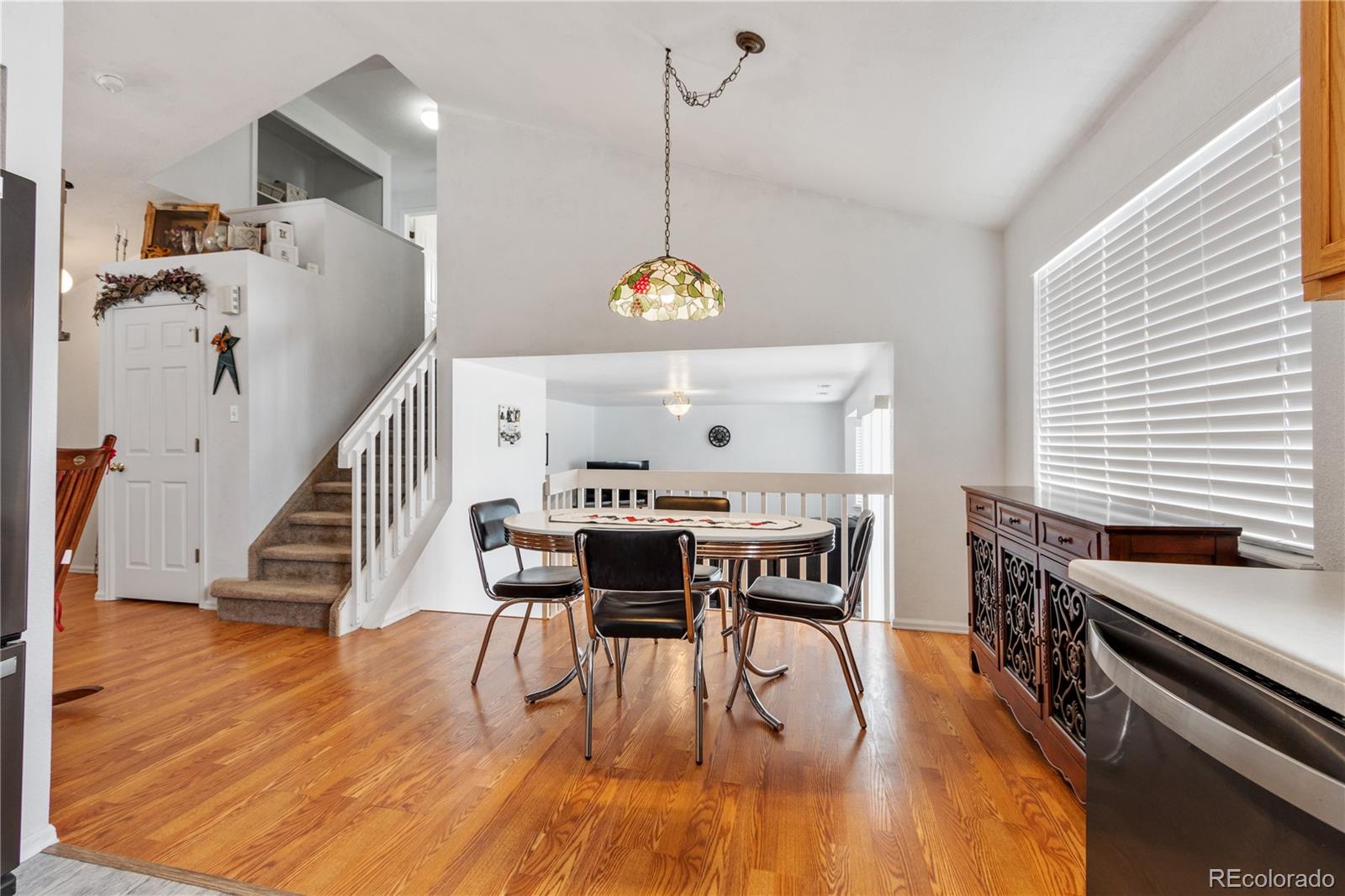 5405 Wolf Street Frederick, CO 80504 - Photo 10 of 36 a view of a dining room with furniture window and wooden floor