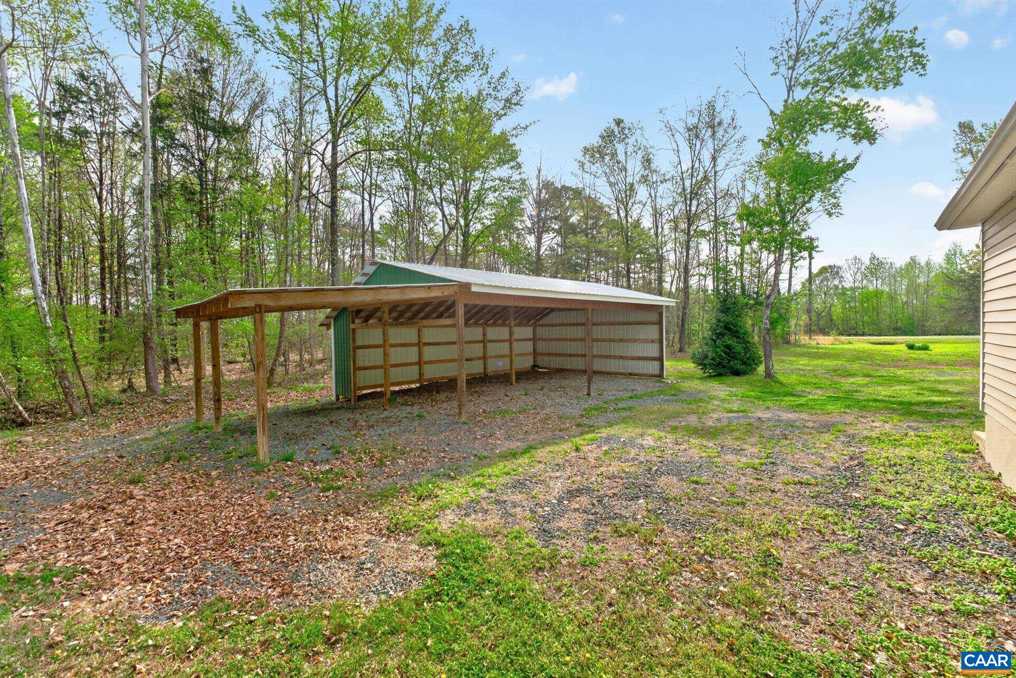 673 Cedar Lane Road Palmyra, VA 22963 - Photo 44 of 47 a backyard of a house with trees and wooden fence