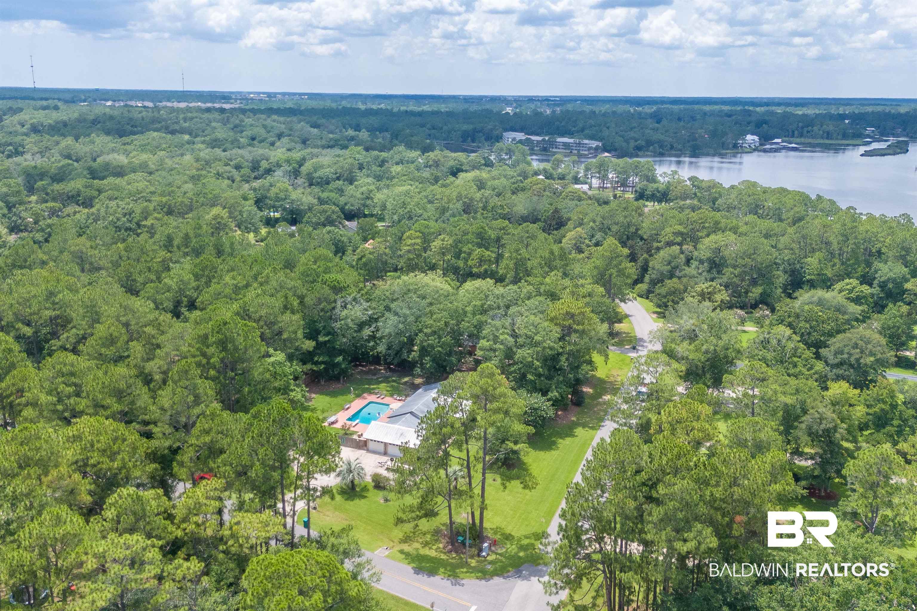 24551 Wolf Bay Drive Foley, AL 36535 - Photo 56 of 59 Aerial view of property's location with a forest and a large body of water