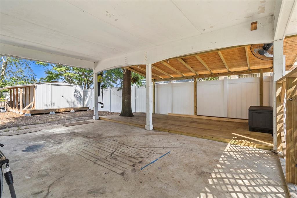 6221 Dalton Street Spring Hill, FL 34606 - Photo 9 of 40 a view of a house with a backyard and a garage