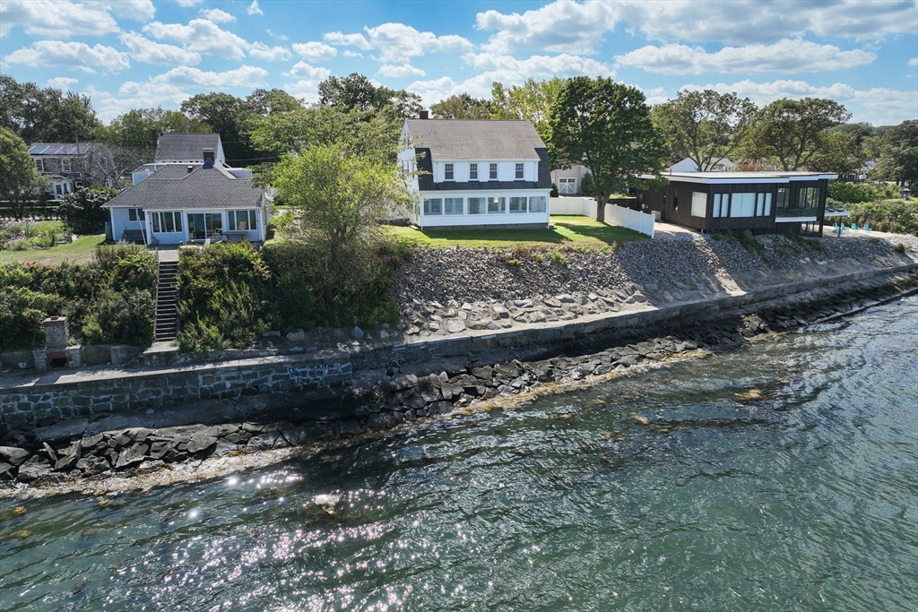 a view of a town with brick house and large trees