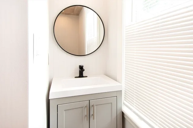 a bathroom with a sink and a mirror