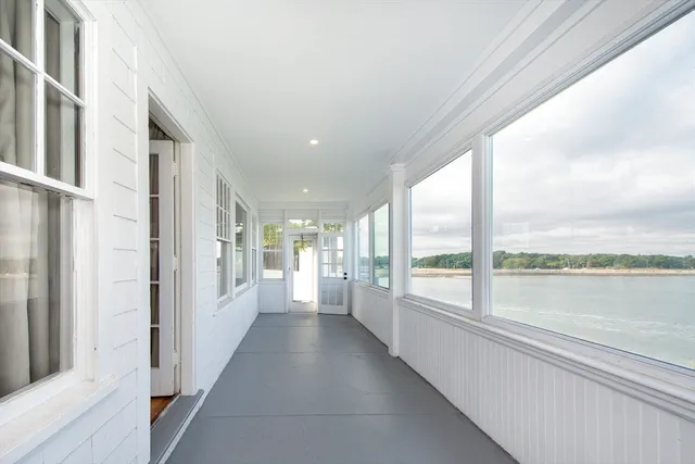 a view of hallway with a large window and swimming pool