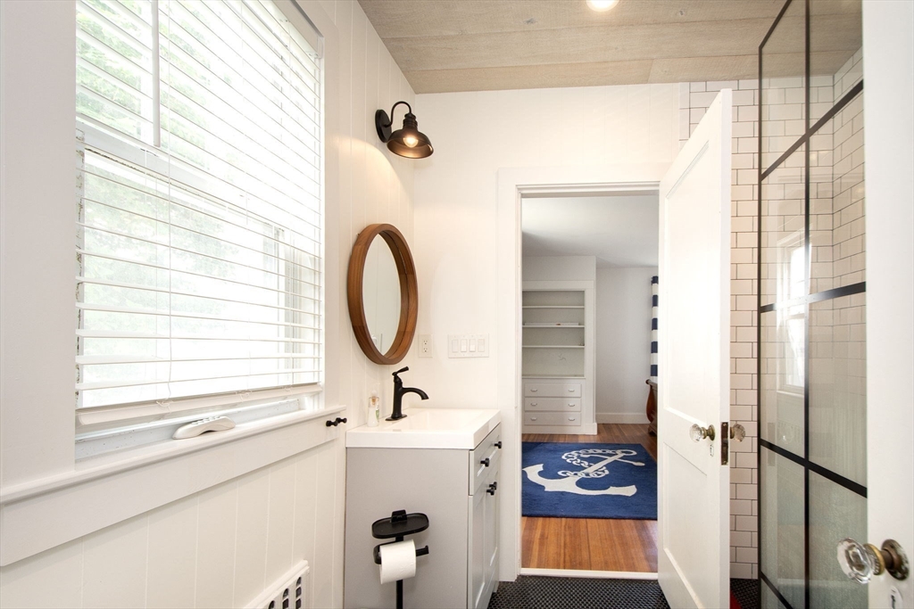 90 Shore Avenue Quincy, MA 02169 - Photo 32 of 38 a bathroom with a sink a mirror and a shower