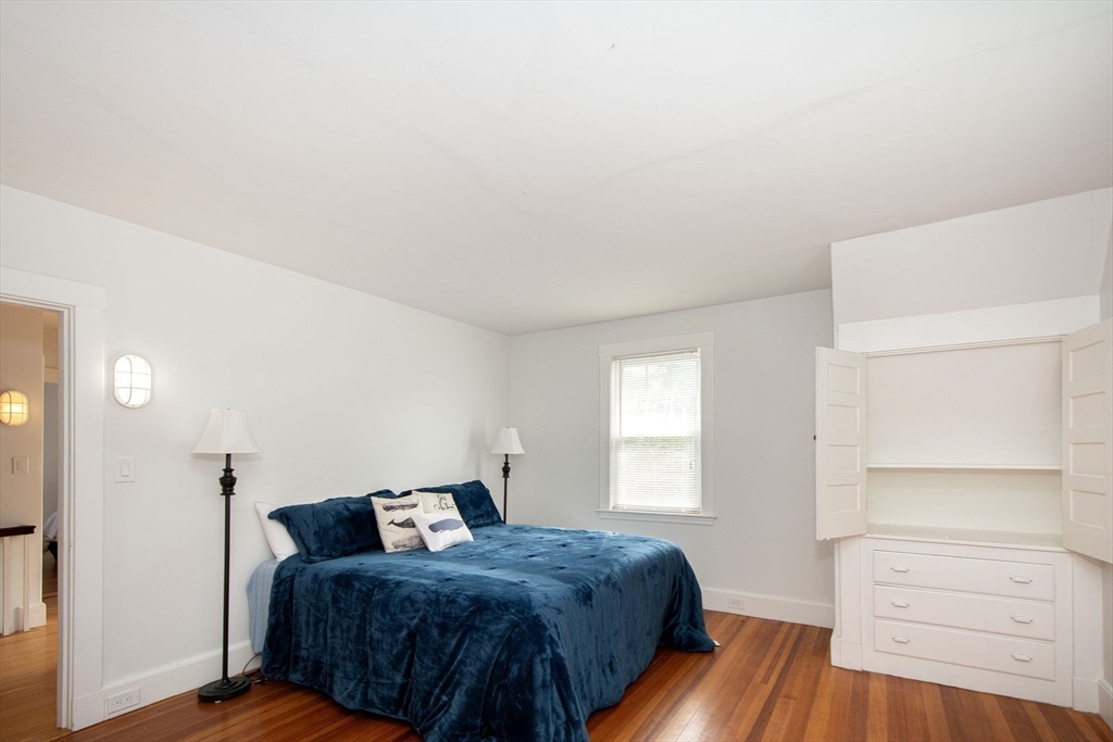 90 Shore Avenue Quincy, MA 02169 - Photo 33 of 38 a bedroom with a bed and wooden floor