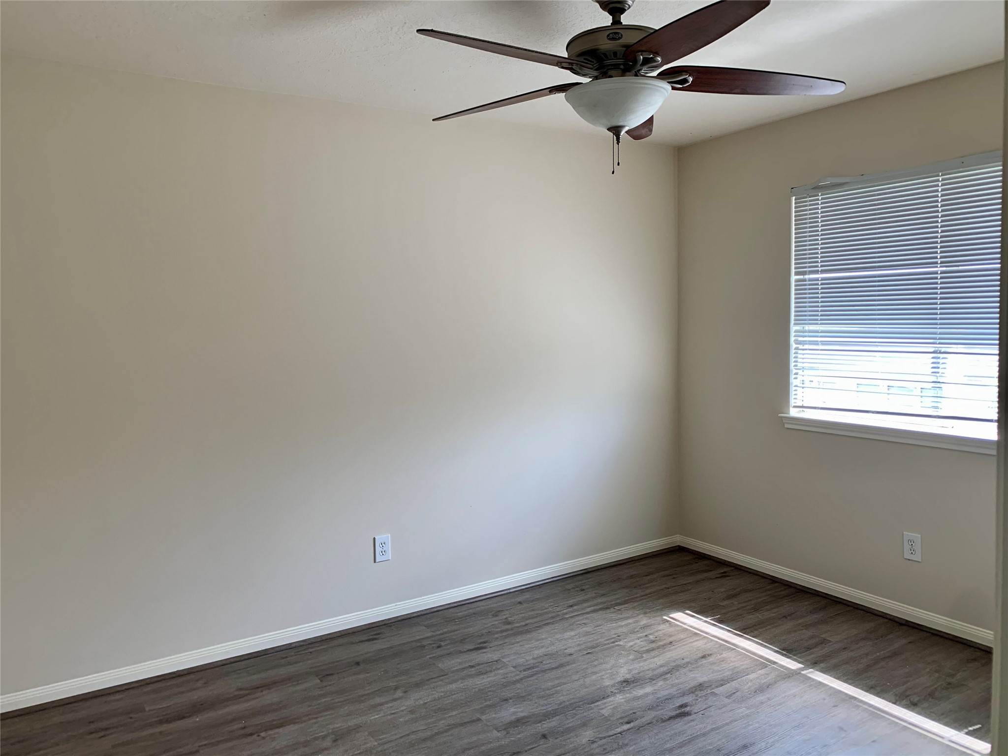 25203 Bluma Ranch Drive Katy, TX 77494 - Photo 16 of 26 a view of an empty room with wooden floor and a window