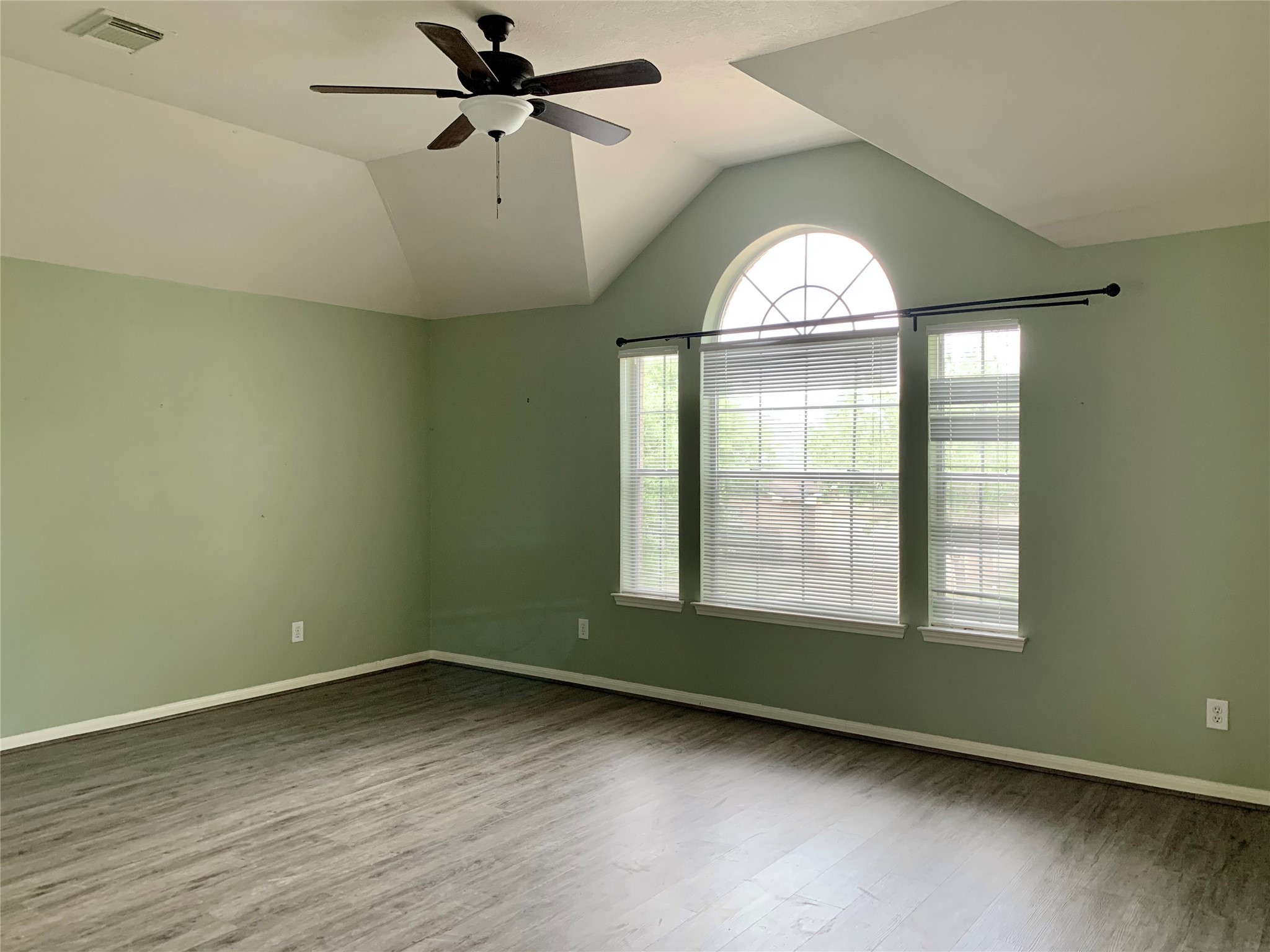25203 Bluma Ranch Drive Katy, TX 77494 - Photo 18 of 26 an empty room with wooden floor fan and windows