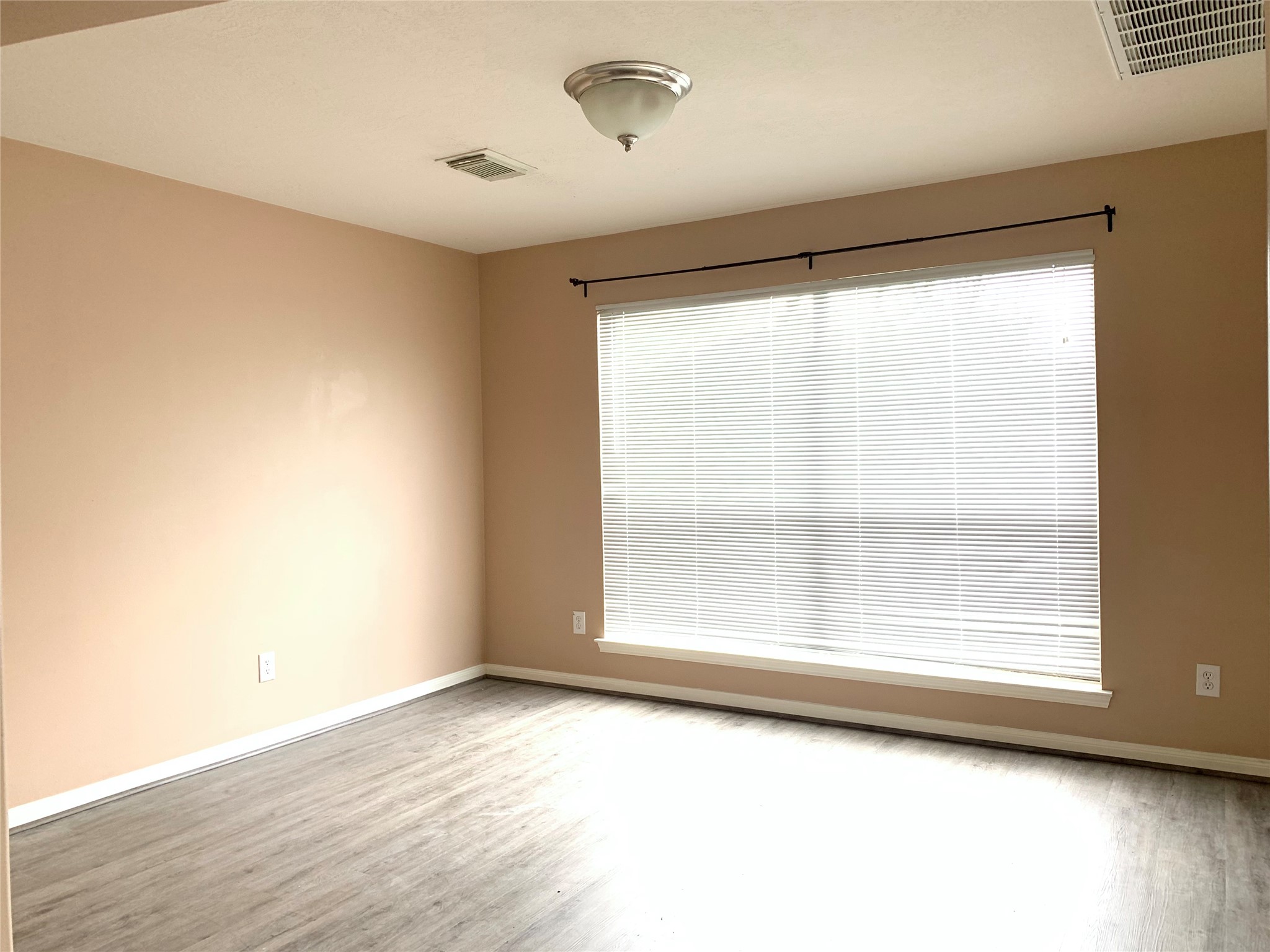 25203 Bluma Ranch Drive Katy, TX 77494 - Photo 5 of 26 a view of an empty room with wooden floor and a window
