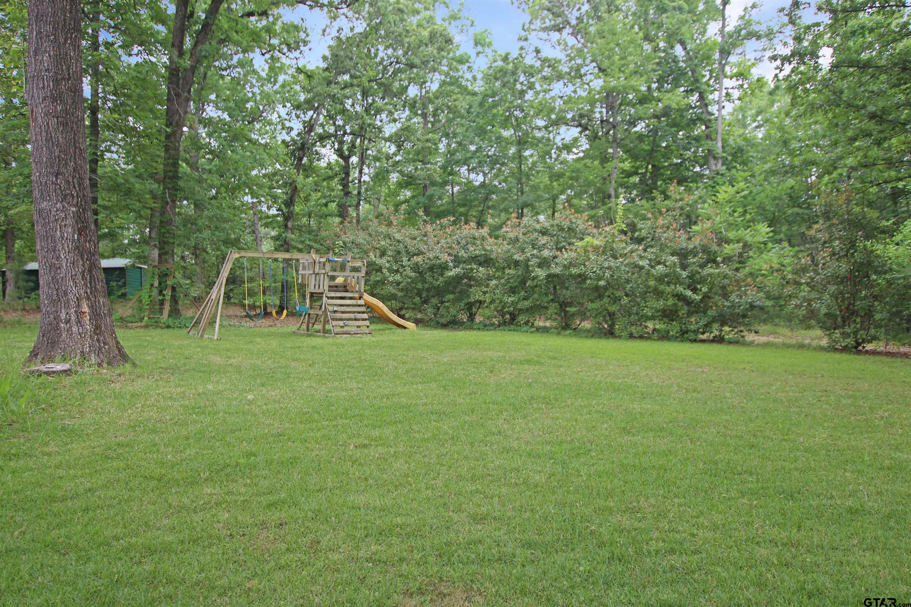 782 Rosie Wady Road Gladewater, TX 75647 - Photo 36 of 48 a view of a backyard with a small park