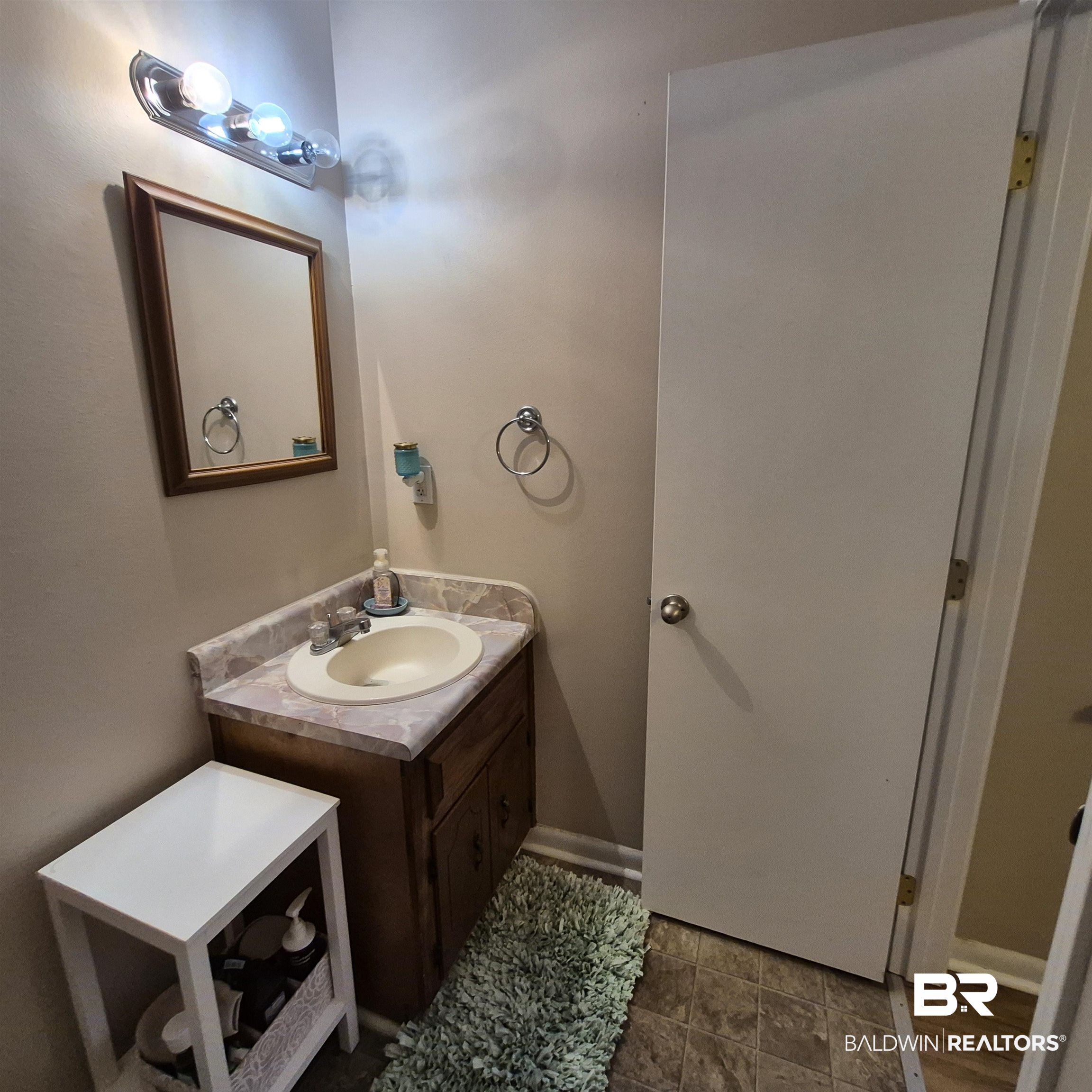 721 Perryman Street Evergreen, AL 36401 - Photo 14 of 26 Half bathroom with vanity and baseboards