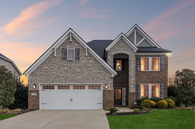 a front view of a house with a yard and garage