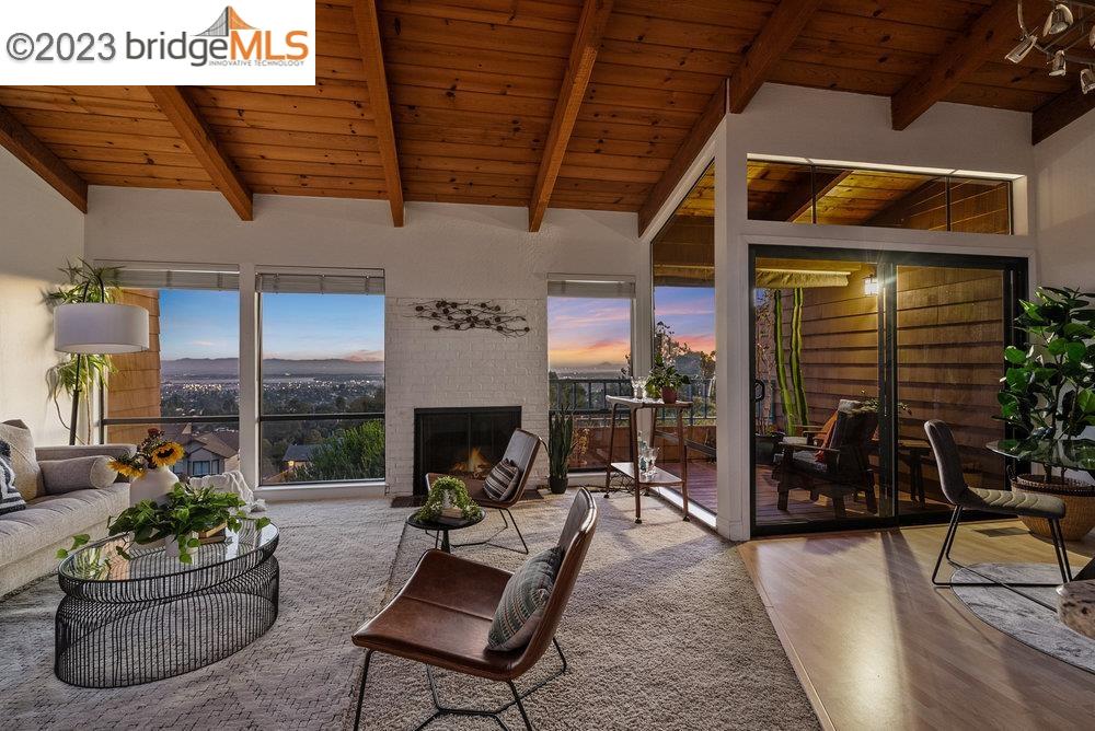 a living room with patio furniture and potted plants