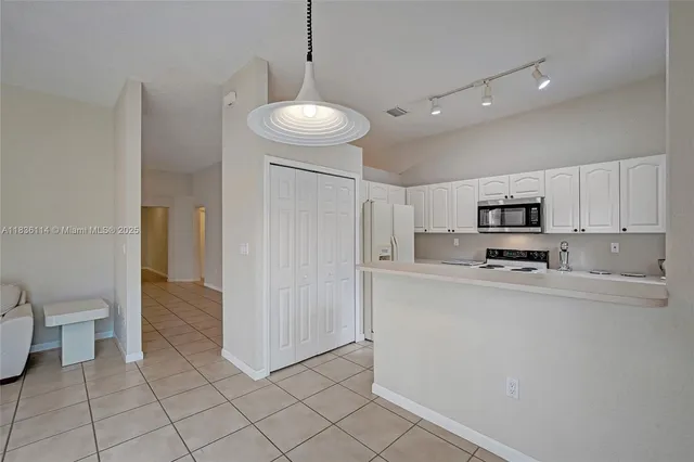 a kitchen with stainless steel appliances a refrigerator and a stove top oven