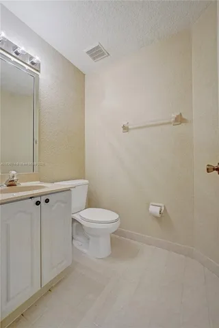 a bathroom with a toilet a sink and shower