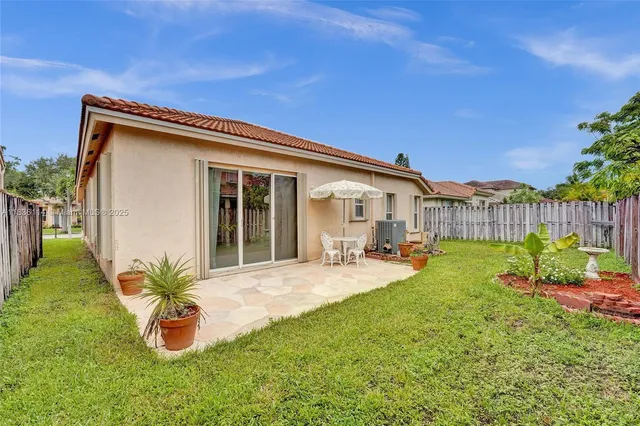 a front view of a house with patio and garden