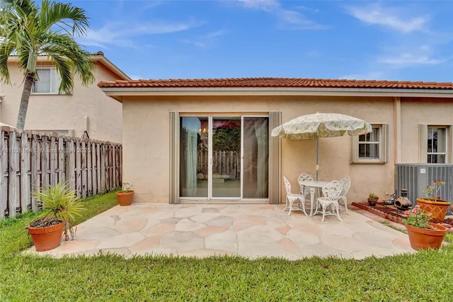 a front view of a house with outdoor seating