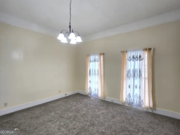 a view of a chandelier in big room and chandelier