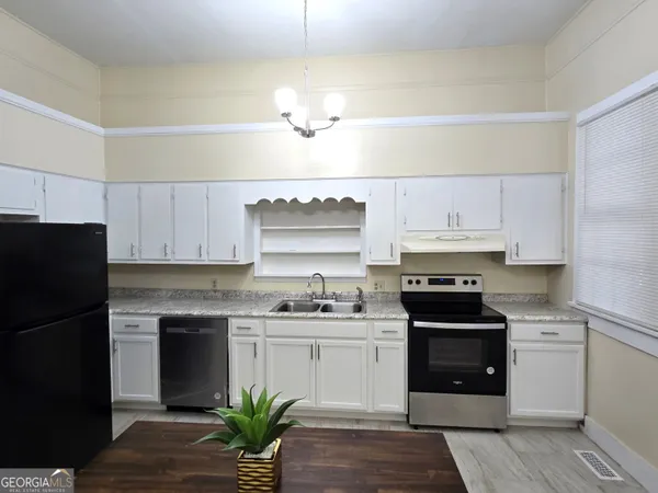 a kitchen with a sink a stove and refrigerator