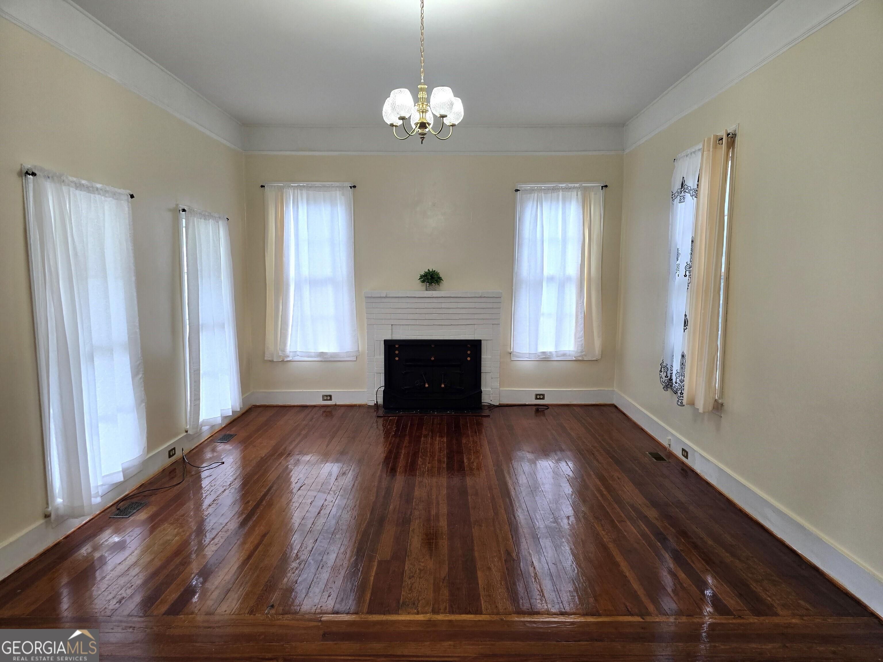 35 Cheatham Street Wadley, GA 30477 - Photo 17 of 18 wooden floor in an empty room with windows