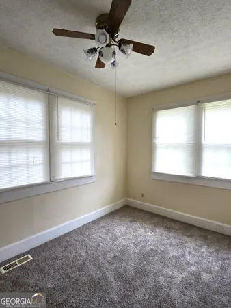 a view of room with a ceiling fan and window