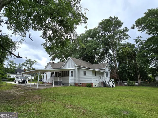 a front view of a house with a garden