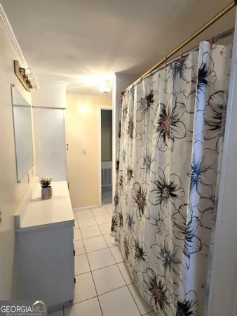 a bathroom with a shower and a sink