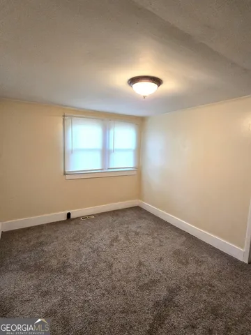 an empty room with a empty space and windows