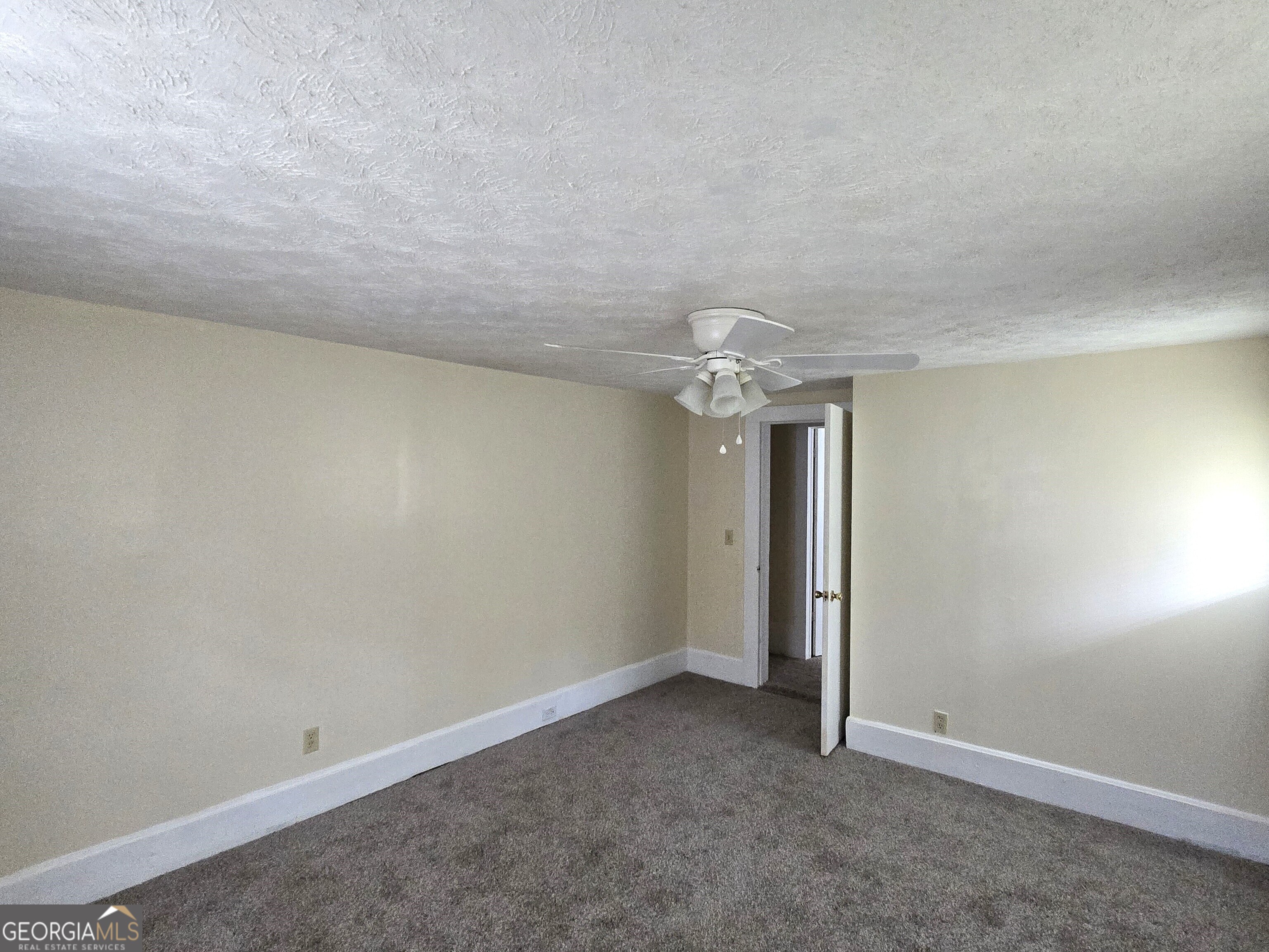 35 Cheatham Street Wadley, GA 30477 - Photo 10 of 18 an empty room with chandelier fan