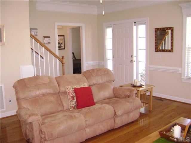 525 Winfred Drive Raleigh, NC 27603 - Photo 5 of 25 Entry area with side window transoms and hardwood floors. Living Room