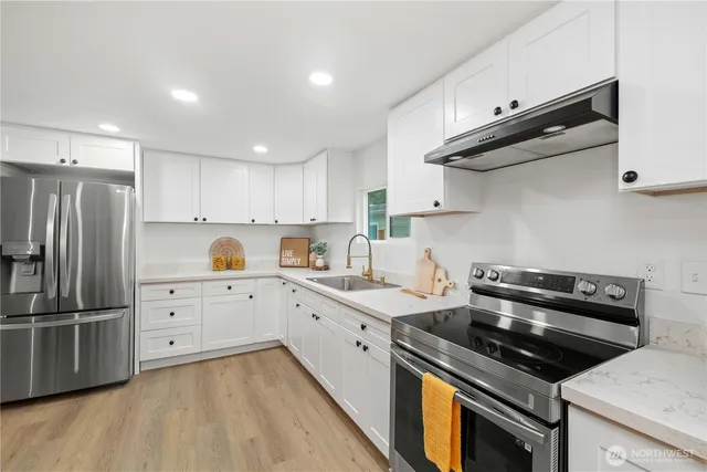 a kitchen with a stove oven and sink