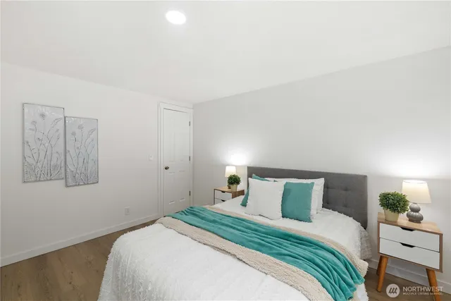 a bedroom with a bed and a painting on the wall