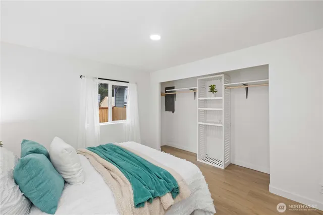 a bedroom with a bed and a window