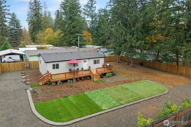 an aerial view of a house with garden space and sitting area