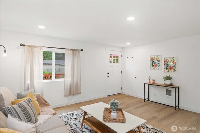a living room with furniture and wooden floor