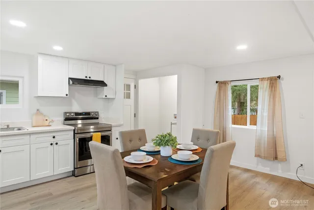 a kitchen with a table and chairs in it