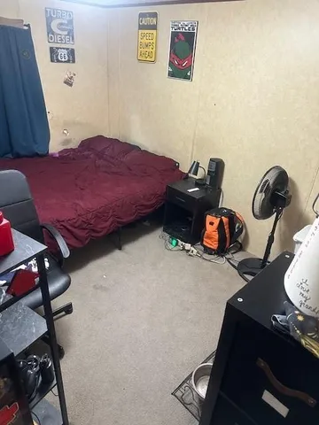 a bathroom with a granite countertop toilet and a sink