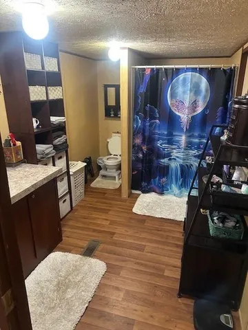 a room with wooden floor and furniture