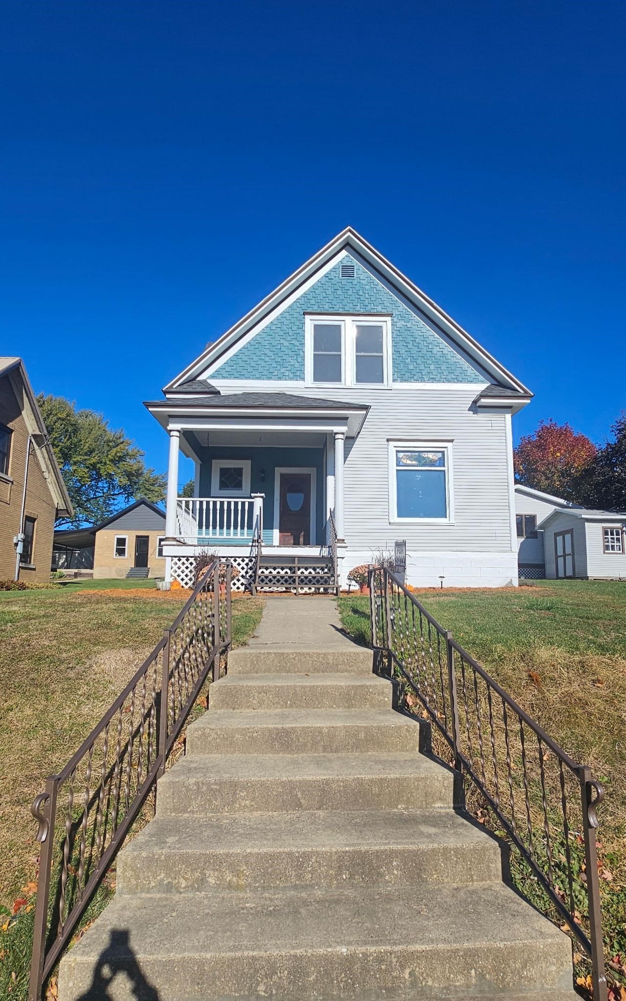 110 West Catlin Street Elizabeth, IL 61028 - Photo 2 of 31 a view of a house with wooden fence