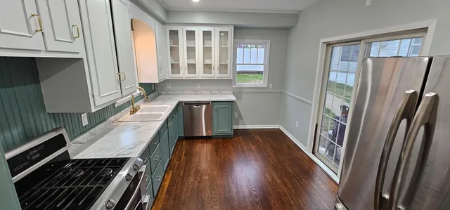 a kitchen with sink and refrigerator
