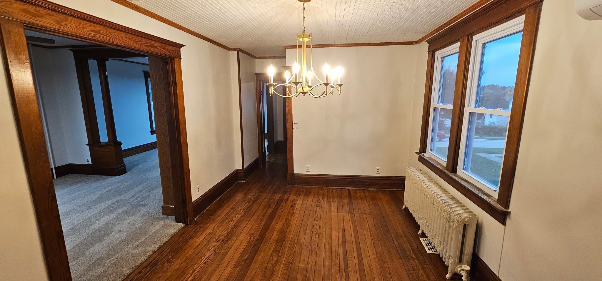 110 West Catlin Street Elizabeth, IL 61028 - Photo 7 of 31 a view of a hallway with wooden floor and staircase