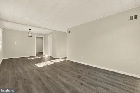 a view of an empty room and wooden floor