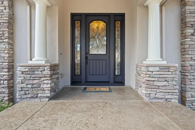 a living room with furniture a fireplace and a large window