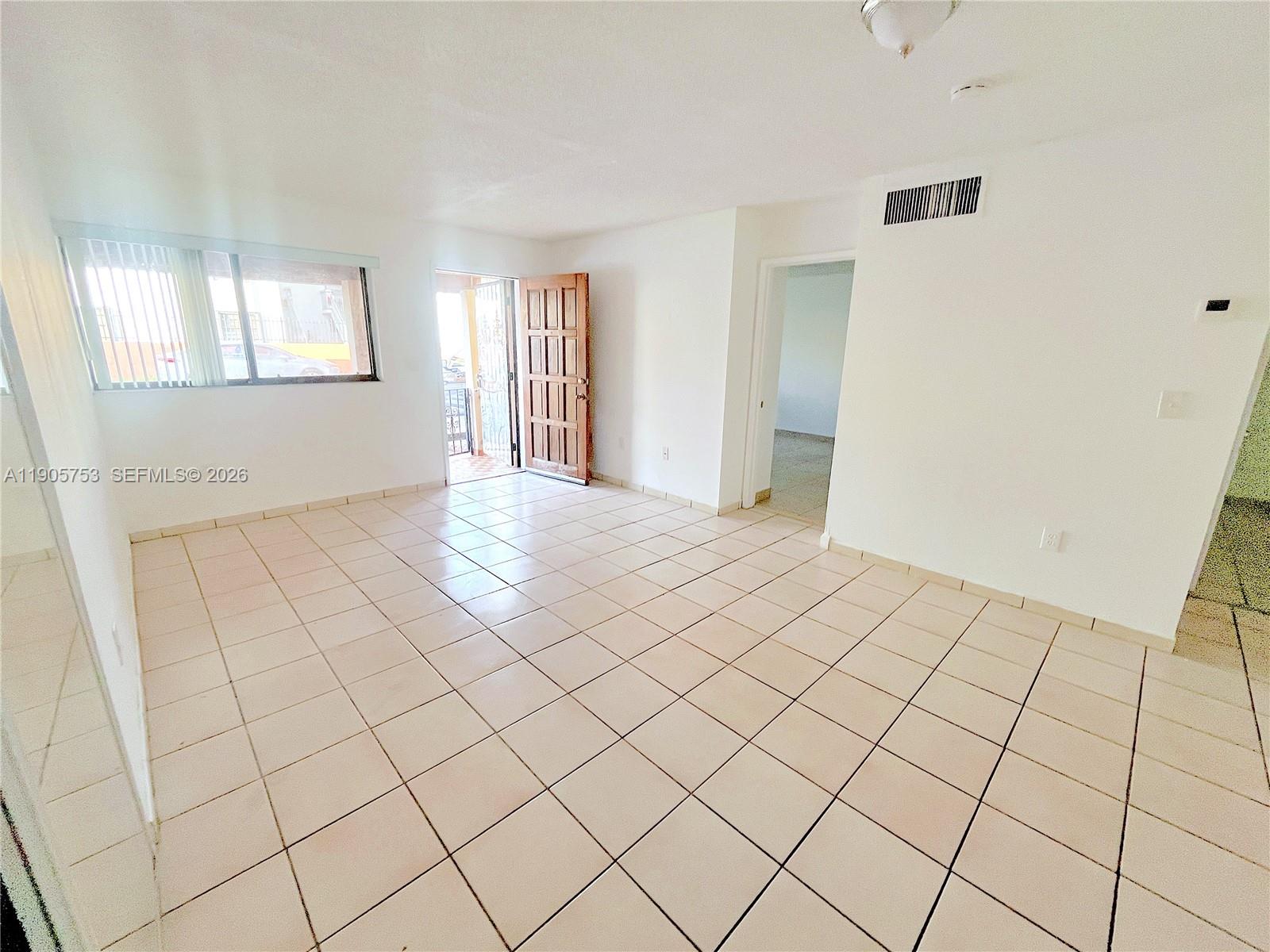2740 West 63rd Street, Unit 104 Hialeah, FL 33016 - Photo 12 of 29 a view of an empty room and window