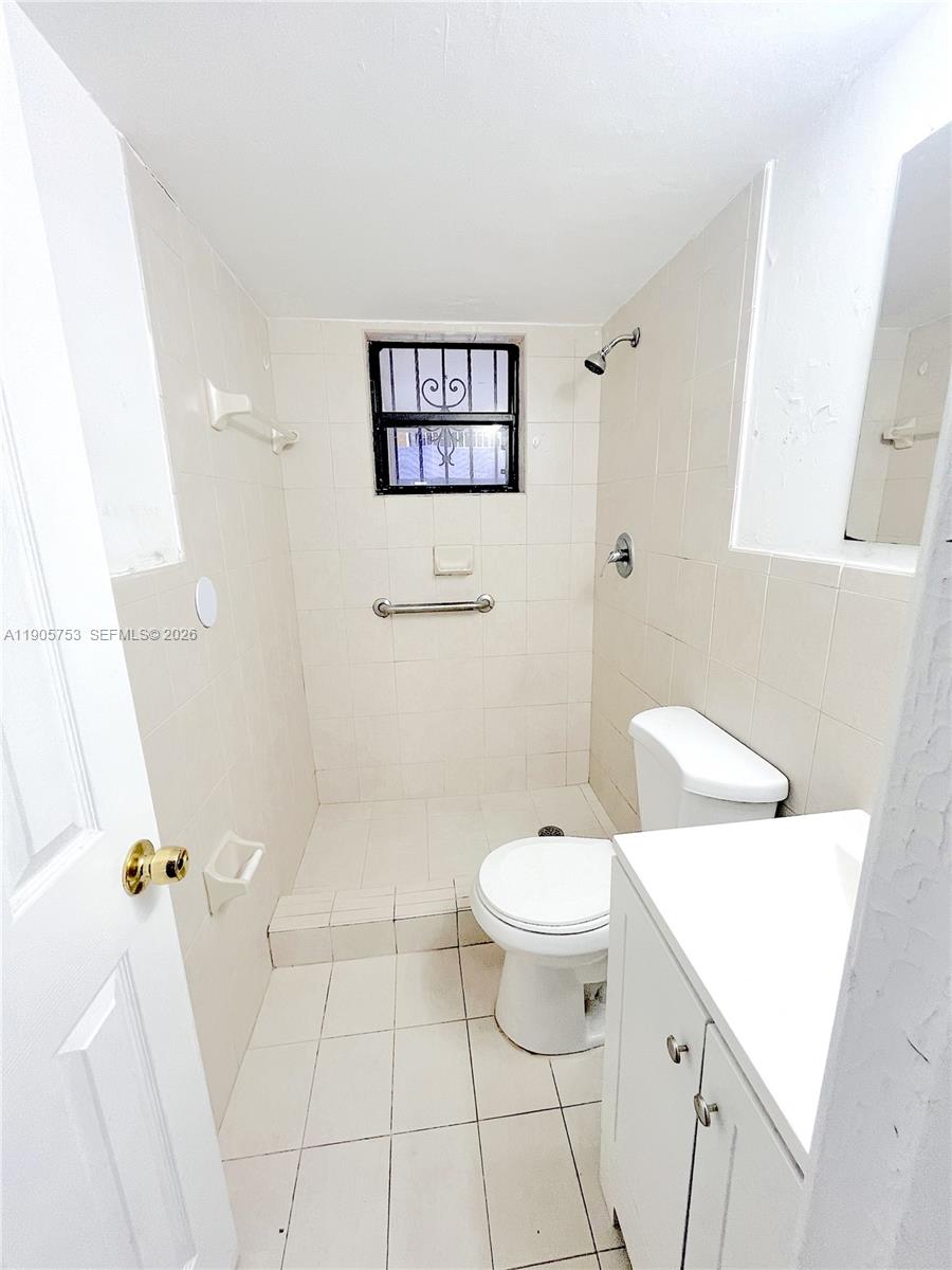 2740 West 63rd Street, Unit 104 Hialeah, FL 33016 - Photo 17 of 29 a white toilet sitting next to a bathroom sink