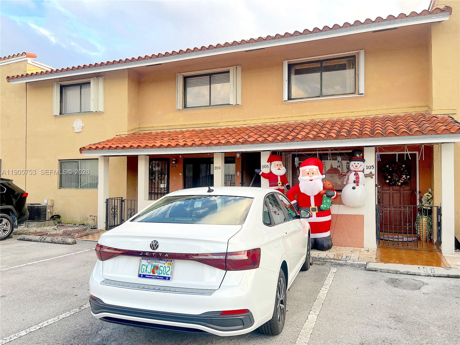 2740 West 63rd Street, Unit 104 Hialeah, FL 33016 - Photo 2 of 29 a front view of a house with a porch