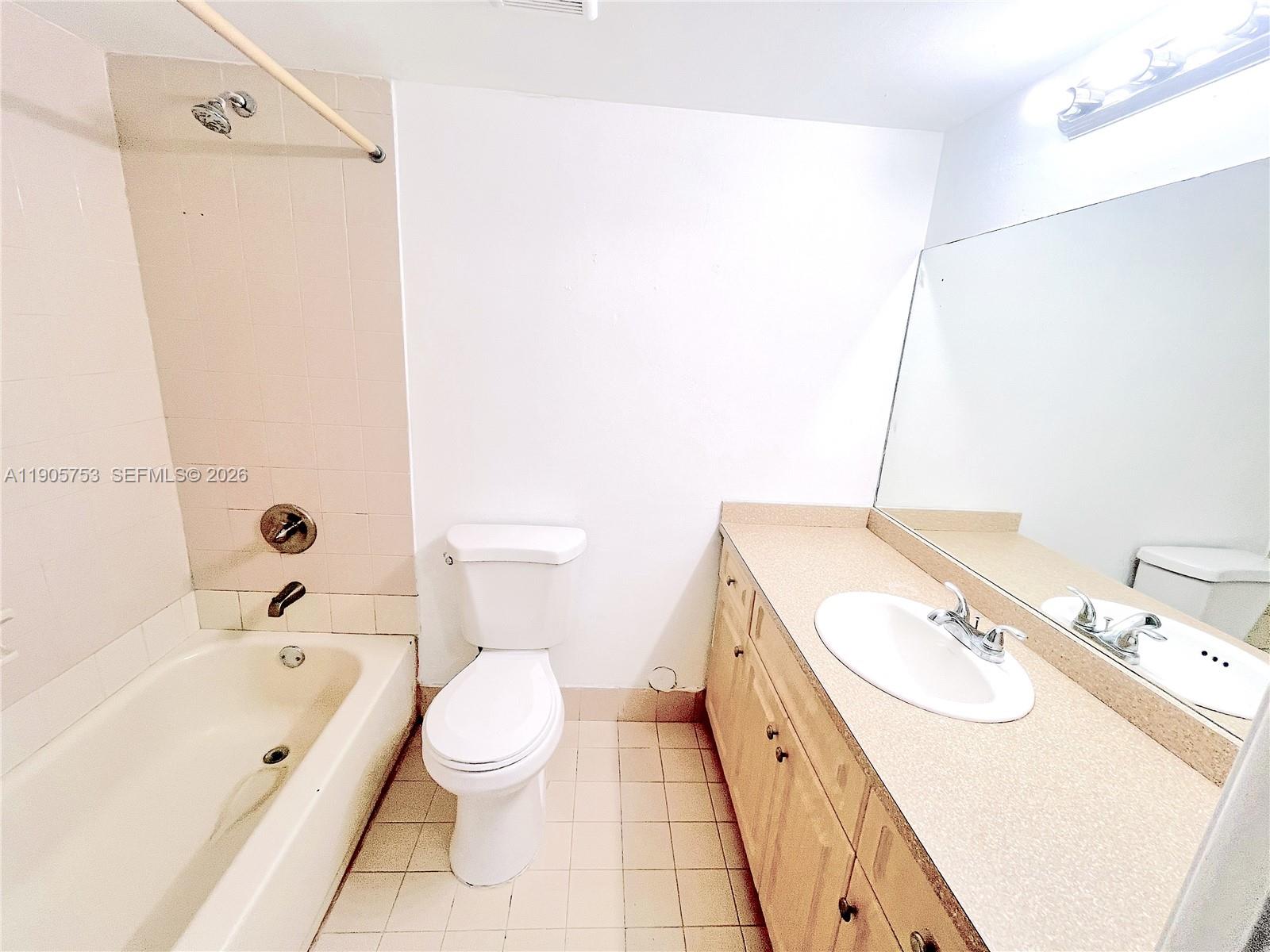 2740 West 63rd Street, Unit 104 Hialeah, FL 33016 - Photo 25 of 29 a bathroom with a granite countertop sink a toilet and shower