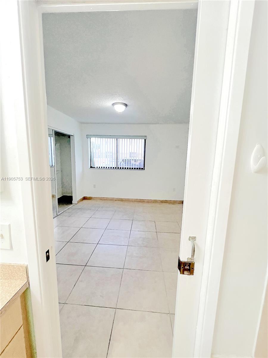 2740 West 63rd Street, Unit 104 Hialeah, FL 33016 - Photo 26 of 29 a view of an empty room and window