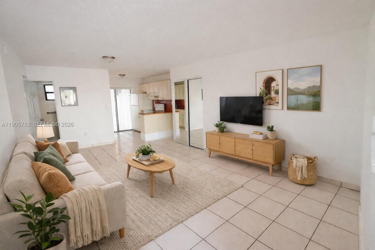 2740 West 63rd Street, Unit 104 Hialeah, FL 33016 - Photo 3 of 29 a living room with furniture and a flat screen tv