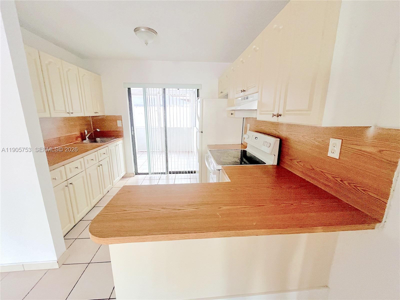 2740 West 63rd Street, Unit 104 Hialeah, FL 33016 - Photo 7 of 29 a bedroom with a bed and a cabinets