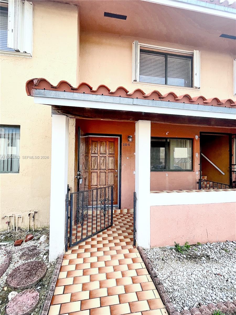 2740 West 63rd Street, Unit 104 Hialeah, FL 33016 - Photo 8 of 29 a front view of a house with a yard and garage
